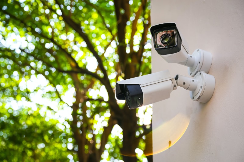 two security cameras attached to side of building