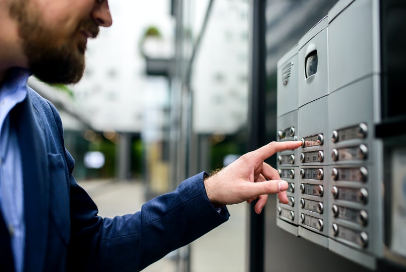 resident of apartment using access control panel to enter building